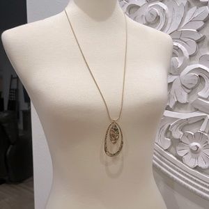 Long gold chain with oval gold dangle charm
